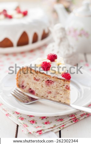 A Piece of Banana Cake with Sugar Glaze Topped with Raspberries and Banana Slices, copy space for your text, shallow dof
