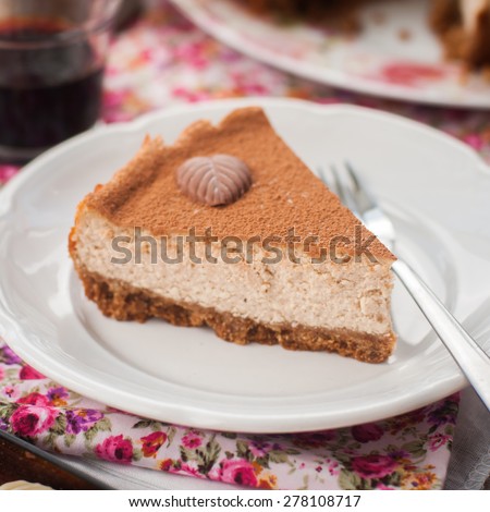 A Slice of Spiced Coffee Cheesecake Dusted with Cocoa Powder, square