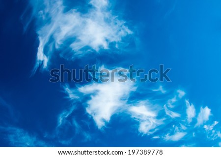 Deep blue sky with bright fluffy clouds