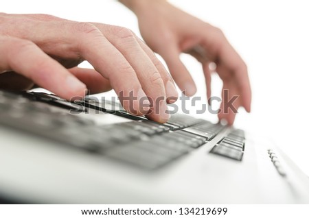 Detail of businessman hands typing on computer keyboard. Over white background.