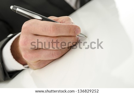 Male hand signing on a white background.