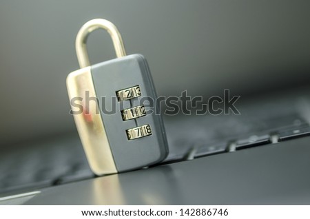 Closeup of padlock on laptop keyboard. Concept of online security.