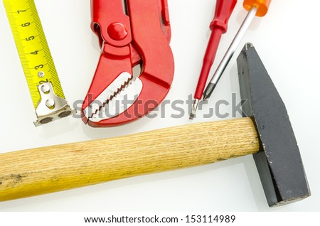 Top view of various work tool on a white table.