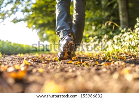 Closeup of male legs hiking in nature Closeup of male legs hiking in nature