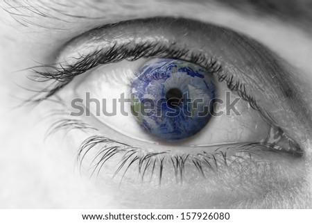 Closeup of planet Earth in human eye. Elements of this image furnished by NASA.