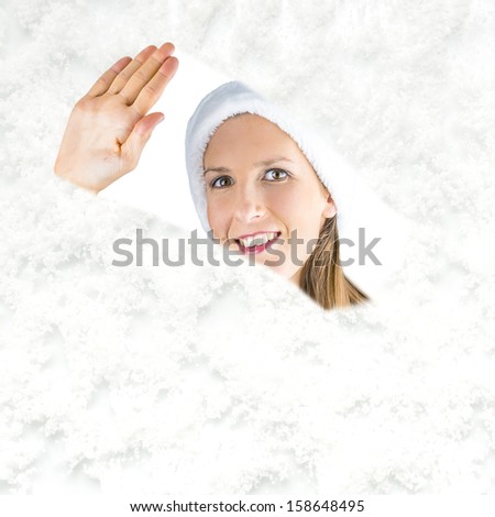 Miss santa clearing snow with a hand wipe from a snowy window and looking through it.