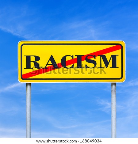 Word racism written on yellow read sign and crossed off.