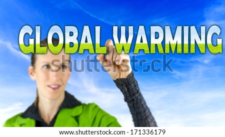 Global Warming concept with a young woman drawing a text sign with graduated green colouring on a blue sky
