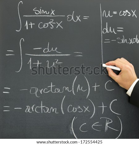 Hand of a businessman writing scientific formula on a blackboard conceptual of a presentation, research, learning or development