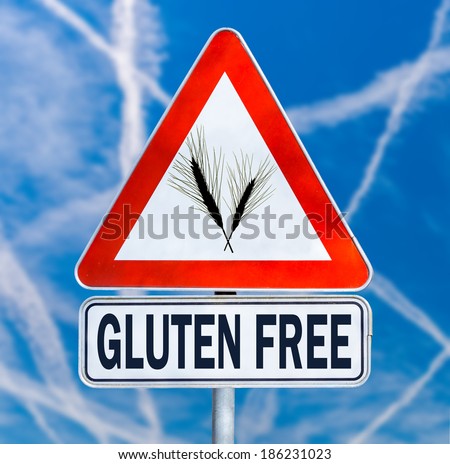 Gluten Free traffic sign with a black silhouette of ears of wheat on a triangular sign with the text below denoting food which is safe for consumption by coeliacs or people with gluten intolerance.