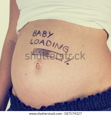 Bare swollen belly of a pregnant young woman with the handwritten words - Baby Loading - and a bar below showing the percentage marking the advancing stages of her pregnancy, toned retro effect.