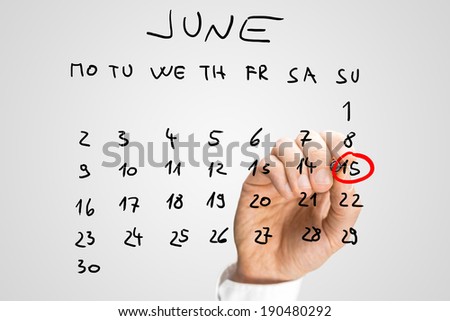 Male hand marking June 15 - Fathers day - on virtual calendar.