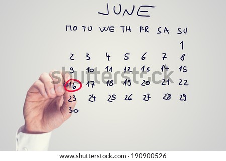 Male hand marking June 16th - International day of the african child - on virtual calendar.