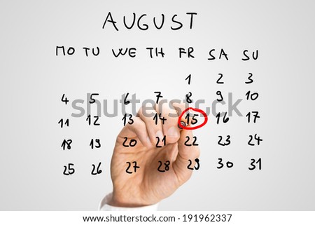 Male hand marking August 15th - Independence day in India - on a virtual calendar.
