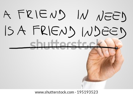 Male hand writing phrase A friend in need is a friend indeed on virtual screen.