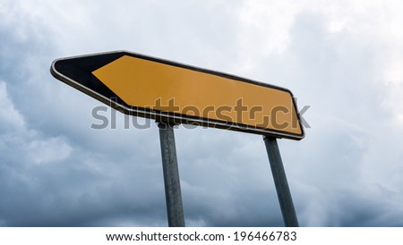 Blank yellow road sign with left pointing arrow.