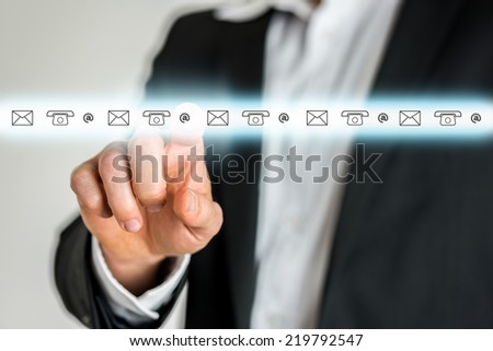 Businessman Selecting Icon from Row of Contact Icons on Touch Screen.