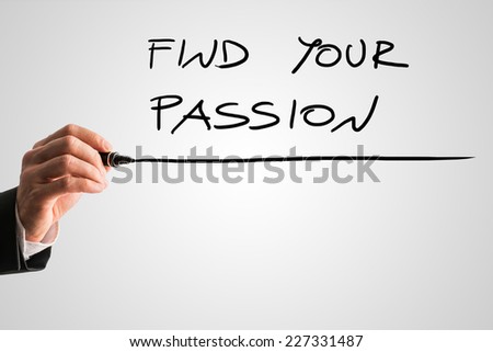 Man writing the idiom - Find your passion - on a virtual interface with a black marker pen over grey with copyspace in a motivational message.
