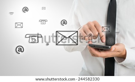 Man using a mobile phone while emitting a clouds of contact icons in a conceptual image.