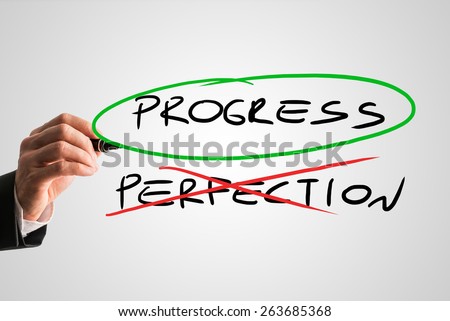 Progress - Perfection concept with a businessman crossing through the handwritten word Perfection in red while ringing Progress in green conceptual of sacrificing perfection to develop and progress.