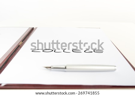 White paper with a College sign placed in an open  leather folder with a pen lying on the paper.