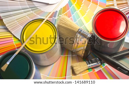 Paint samples. Sample of colorful paint. Cans of red, yellow and green paint.