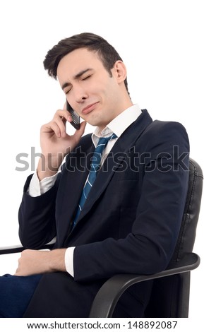 Young businessman crying on the phone. Upsetting business phone conversation. Isolated on white background.