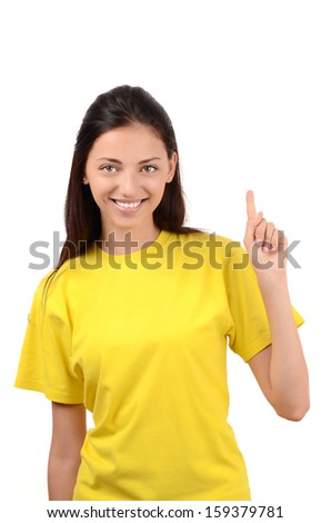 Beautiful girl pointing up. Attractive girl with yellow t-shirt. Isolated on white.