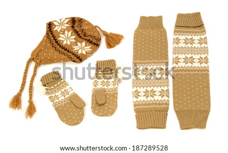 Brown winter accessories isolated on white background. Wool mittens, hat and  leg warmers nicely arranged.