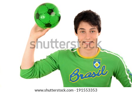 Happy Brazilian man with a football ball in the hands. Attractive man with Brasil on his green blouse. Isolated on white.