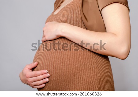Close up on pregnant belly. Woman expecting a baby.