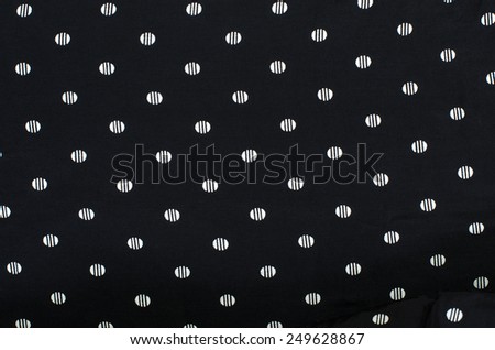 Polka dots background. Closeup on black with white dots with stripes pattern.