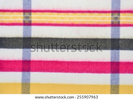 Color stripe wool pattern. Yellow, red colors stripes with rhombus design on fabric as a background.