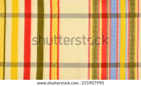 Color stripe wool pattern. Yellow, green,red colors stripes with rhombus design on fabric as a background.