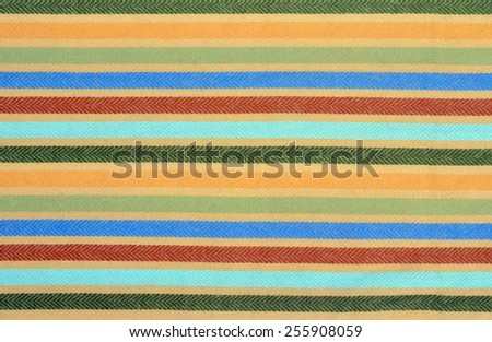 Blue, green,red colors stripes on fabric as a background. Color stripe wool scarf.