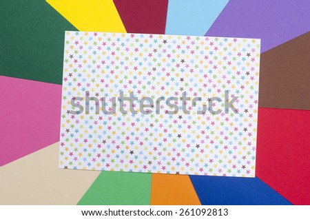 White sheet paper with stars. Craft paper with color stars on rainbow multicolor paper background.