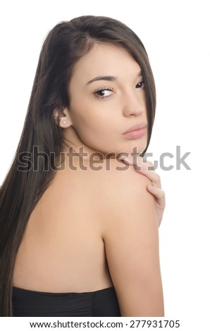 Beautiful brunette girl with long hair. Beauty portrait. Young attractive brunette woman looking over her shoulder. Isolated on white background.