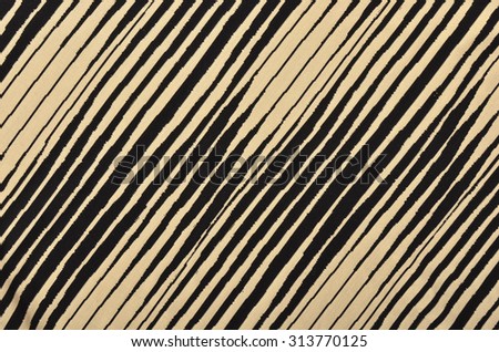 Black and brown with white striped background. Asymmetric diagonal stripes pattern on fabric.