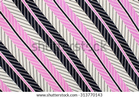 Pink and black striped background. Abstract diagonal stripes pattern on fabric.