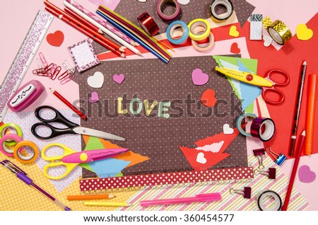 Arts and craft supplies for Saint Valentine\'s. Color paper, pencils, different washi tapes, craft scissors, hearts supplies for decoration.