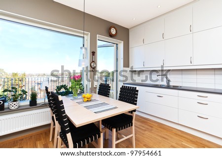interior of a kitchen with dinging-table by the window with a view
