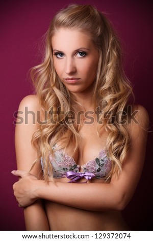beautiful blond woman in floral bra, studio shoot on a violet background,  glamour photo