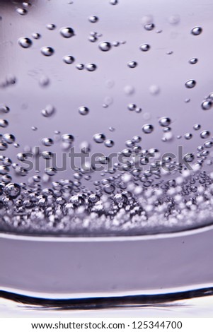 Soda water in glass. Isolated on white background. bubbles water in glass