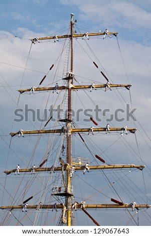 Working in the rigging of a brig.Sailors on masts
