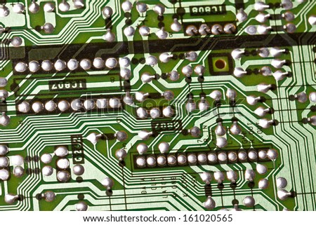 The modern printed-circuit board with electronic components macro background