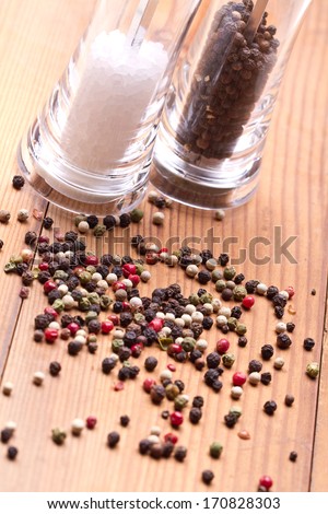 pepper in silver spoon on wooden background