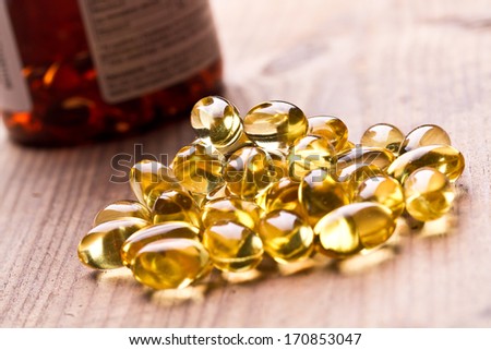 Cod Liver Oil Omega 3 Gel Capsules Isolated On Wooden Background