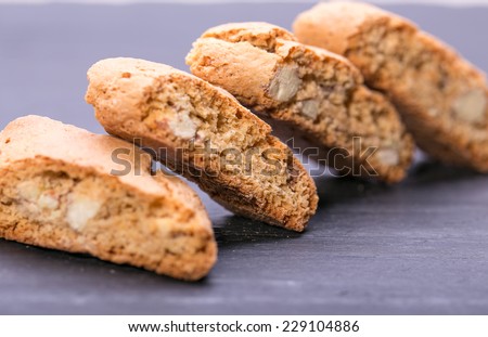 Italian cookies with almonds - cantuccini on black stones plates