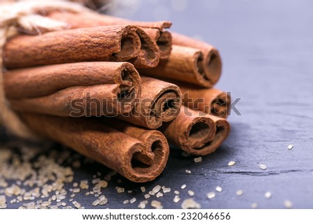 Star anise with cinnamon sticks over black stones background at christmas time