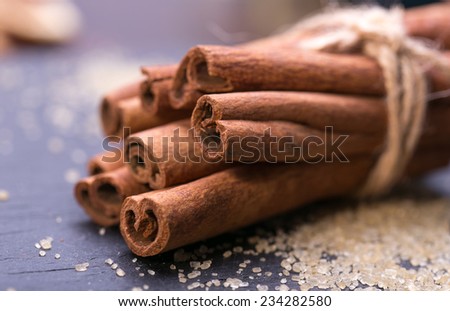 cinnamon sticks over black stones background at christmas time